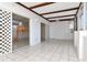 A covered patio featuring white tile floors, exposed beam ceiling, and access to the outdoors with sliding glass doors at 1321 N Mcmullen Booth Rd # 1321, Clearwater, FL 33759
