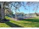 Community tennis court surrounded by trees and greenery at 1321 N Mcmullen Booth Rd # 1321, Clearwater, FL 33759