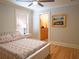 Comfortable bedroom features a queen bed and an ensuite bathroom with warm-toned walls and cabinets at 13922 Oak Forest N Blvd, Seminole, FL 33776