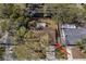 Home aerial view showing the property lines and surrounding neighborhood with mature trees at 1582 Sandalwood Dr, Dunedin, FL 34698