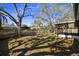 This spacious backyard features mature trees and a fenced perimeter for privacy at 1582 Sandalwood Dr, Dunedin, FL 34698