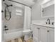 Updated bathroom with tiled shower and tub, updated vanity, and marble-look countertops at 1582 Sandalwood Dr, Dunedin, FL 34698
