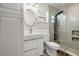 Modern bathroom featuring tiled shower with rainfall head, updated vanity, and stylish fixtures at 1582 Sandalwood Dr, Dunedin, FL 34698