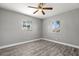 Bedroom featuring modern wood-look floors, and a pair of windows, ready for personalization at 1582 Sandalwood Dr, Dunedin, FL 34698