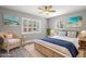 Comfortable bedroom featuring ample natural light and wicker furniture at 1582 Sandalwood Dr, Dunedin, FL 34698