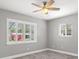 Neutral bedroom featuring wood-look flooring, and a set of windows dressed with plantation shutters at 1582 Sandalwood Dr, Dunedin, FL 34698