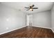 Neutral bedroom featuring neutral walls, ceiling fan and hardwood floors at 1582 Sandalwood Dr, Dunedin, FL 34698