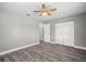 Spacious bedroom featuring wood-look flooring, closet and a ceiling fan at 1582 Sandalwood Dr, Dunedin, FL 34698