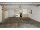 The spacious garage includes laundry area, storage cabinets, and access to the house at 1582 Sandalwood Dr, Dunedin, FL 34698