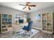 Bright home office with built-in bookshelves and large windows at 1582 Sandalwood Dr, Dunedin, FL 34698