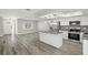 Well-lit kitchen with stainless steel appliances, granite countertops, and a functional island at 1582 Sandalwood Dr, Dunedin, FL 34698