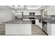 Modern kitchen featuring stainless steel appliances, granite countertops, and custom cabinetry at 1582 Sandalwood Dr, Dunedin, FL 34698