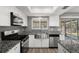 Well-lit kitchen features stainless steel appliances, granite countertops, and a stainless steel sink at 1582 Sandalwood Dr, Dunedin, FL 34698