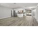 Open-concept kitchen and living room with stainless steel appliances, hardwood floors, and modern fixtures at 1582 Sandalwood Dr, Dunedin, FL 34698