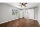 Empty main bedroom featuring neutral walls, a ceiling fan, and a barn door closet at 1582 Sandalwood Dr, Dunedin, FL 34698