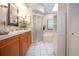 Well-lit bathroom with vanity, shower, tub, and white tiled floor at 1601 E Del Webb Blvd, Sun City Center, FL 33573