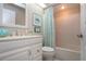 Bathroom featuring a white vanity, framed art, and a tub-shower combination with a stylish curtain at 1601 E Del Webb Blvd, Sun City Center, FL 33573
