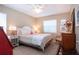 Cozy bedroom with a comfortable bed, ceiling fan, neutral decor, and a bright window at 1601 E Del Webb Blvd, Sun City Center, FL 33573