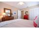 Comfortable bedroom with a soft bed, colorful accents, ample closet space, and natural light at 1601 E Del Webb Blvd, Sun City Center, FL 33573