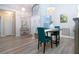 Dining space showcasing hardwood floors, stylish lighting, and ample space for entertaining at 1601 E Del Webb Blvd, Sun City Center, FL 33573