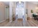 Bright foyer with hardwood floors, complemented by elegant furniture and natural light at 1601 E Del Webb Blvd, Sun City Center, FL 33573