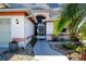Front entrance with a secure screen door, and a charming walkway adorned with plants at 1601 E Del Webb Blvd, Sun City Center, FL 33573