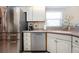 Stainless steel refrigerator and appliances accent the bright and efficient kitchen design at 1601 E Del Webb Blvd, Sun City Center, FL 33573