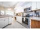 Bright open kitchen with modern stainless steel appliances and abundant cabinet space at 1601 E Del Webb Blvd, Sun City Center, FL 33573