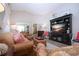 Bright living room features a large entertainment center and comfortable seating at 1601 E Del Webb Blvd, Sun City Center, FL 33573
