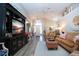 Open-concept living room featuring a large TV and easy access to front entrance at 1601 E Del Webb Blvd, Sun City Center, FL 33573