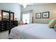 Cozy main bedroom with a four-poster bed, dark furniture, and soft lighting at 1601 E Del Webb Blvd, Sun City Center, FL 33573