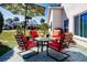 Inviting patio with comfortable seating under a shaded umbrella, perfect for outdoor relaxation and gatherings at 1601 E Del Webb Blvd, Sun City Center, FL 33573