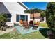 Outdoor patio space with comfortable seating, a stylish umbrella, and serene backyard views at 1601 E Del Webb Blvd, Sun City Center, FL 33573