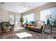 Relaxing sunroom filled with natural light, comfortable seating, and plants at 1601 E Del Webb Blvd, Sun City Center, FL 33573
