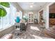 Bright sunroom with neutral tones, comfortable sofa, and many plants at 1601 E Del Webb Blvd, Sun City Center, FL 33573