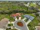 Expansive aerial view showcasing a charming home and verdant surroundings, near a golf course and lakes at 1604 Azalea Landings Ct, Sun City Center, FL 33573