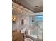 Bathroom featuring decorative tiles, a glass enclosed shower, and a granite topped vanity at 1616 S Lake Ave # 4, Clearwater, FL 33756
