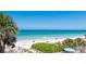 Beautiful beach with white sand, clear blue water, and lush greenery at 1616 S Lake Ave # 4, Clearwater, FL 33756