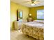 Bedroom featuring two twin beds with floral comforters, bright walls, and a ceiling fan at 1616 S Lake Ave # 4, Clearwater, FL 33756