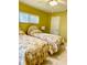 Bedroom featuring two twin beds with floral comforters, bright walls, and a ceiling fan at 1616 S Lake Ave # 4, Clearwater, FL 33756