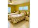 Sunny bedroom showcases twin beds, bedside tables, and windows at 1616 S Lake Ave # 4, Clearwater, FL 33756