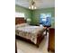Comfortable bedroom with a full bed, desk, and a beautiful outdoor view from the window at 1616 S Lake Ave # 4, Clearwater, FL 33756