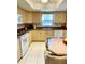 Bright kitchen features tile floors, white appliances, and updated countertops at 1616 S Lake Ave # 4, Clearwater, FL 33756