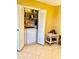 Bright laundry area featuring a washer, dryer, shelving, and white bi-fold doors at 1616 S Lake Ave # 4, Clearwater, FL 33756