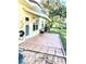 Exterior shot of a patio with a retractable awning and access to the backyard at 1616 S Lake Ave # 4, Clearwater, FL 33756