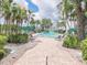 An inviting community pool area surrounded by palm trees, lush landscaping, and comfortable seating at 1616 S Lake Ave # 4, Clearwater, FL 33756