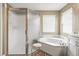 Bright bathroom featuring a soaking tub, tiled shower, and natural light at 1709 Tremont Ct, Sun City Center, FL 33573