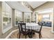 Cozy dining area with wood floors and bright windows creates an inviting atmosphere at 1709 Tremont Ct, Sun City Center, FL 33573