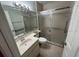 Well-lit bathroom with a vanity sink, toilet, and walk-in shower at 1725 Pine Ridge E Way # C, Palm Harbor, FL 34684