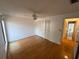 Spacious bedroom featuring a ceiling fan, wood floors, and closet, creating a comfortable retreat at 1725 Pine Ridge E Way # C, Palm Harbor, FL 34684